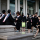 Graduates stand on the steps in front of the academic building at Fudan University in Shanghai.